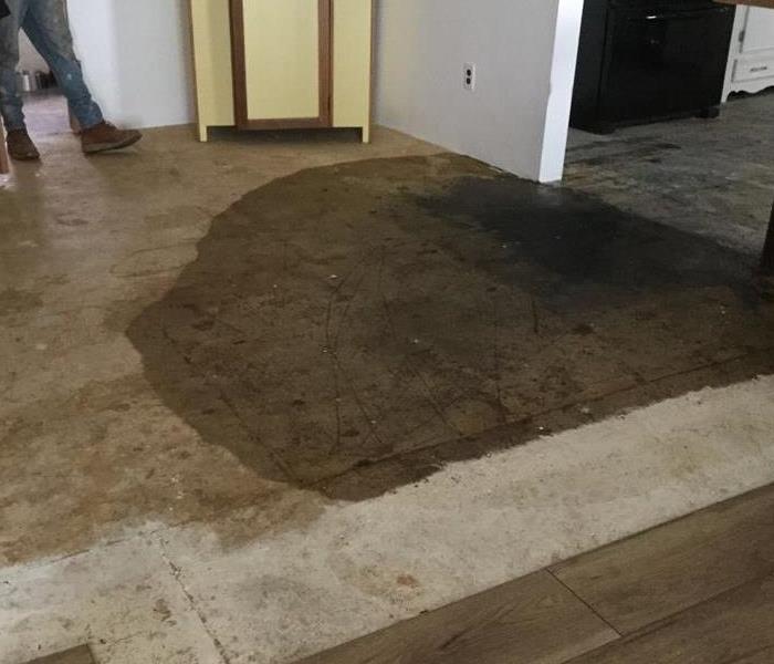 flooring with a large water stain 