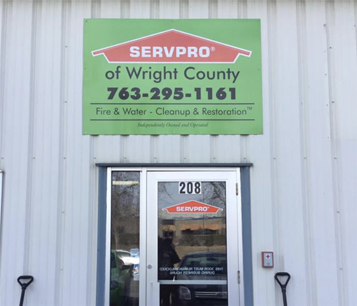 the front of a building with a sign that says SERVPRO of Wright County